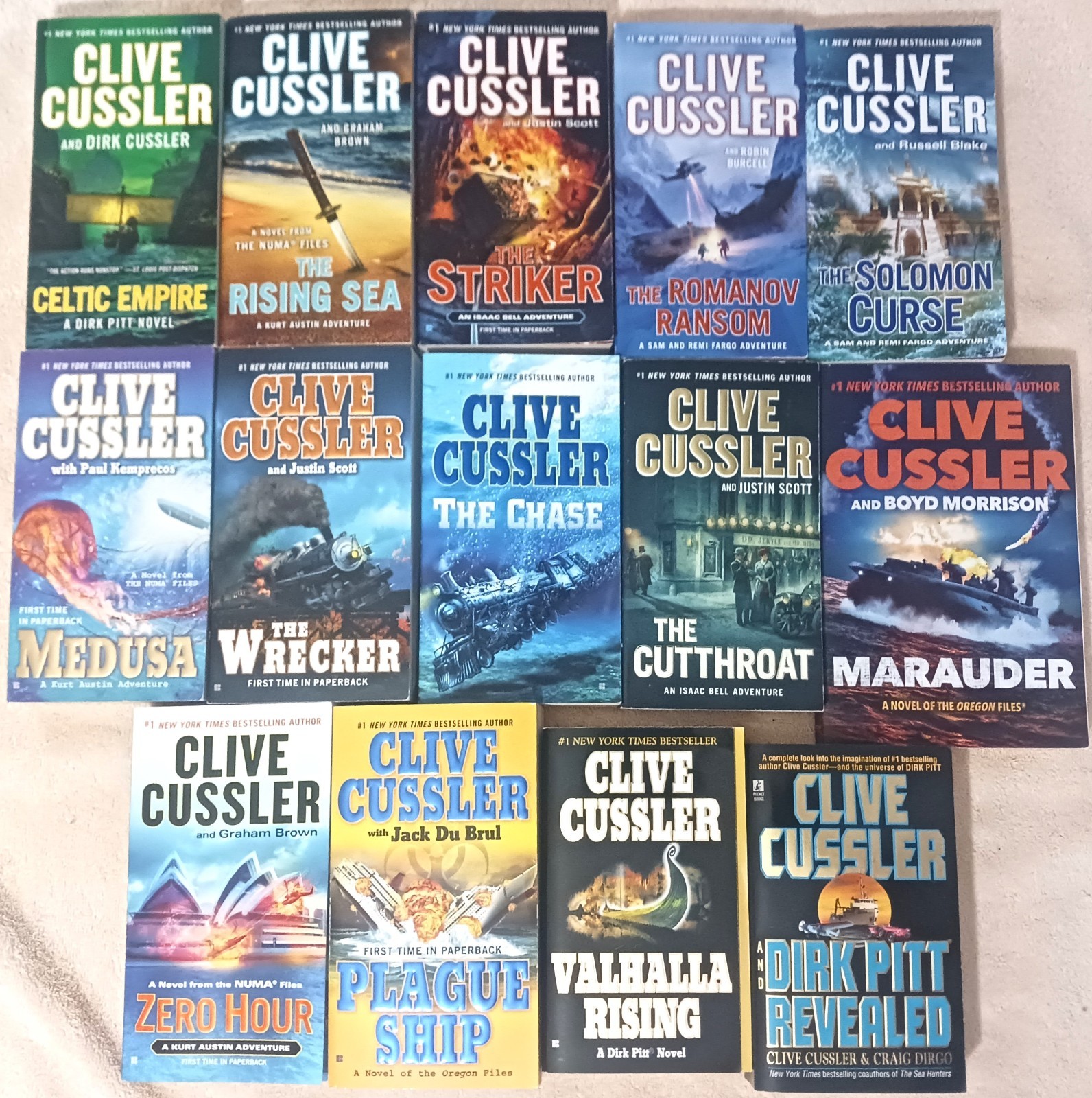 Mixed Lot of 14 Clive Cussler Paperback books – Pitt – Bell – Numa – VG
